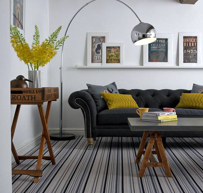 Серый диван сочетается с серыми полосками на полу фото